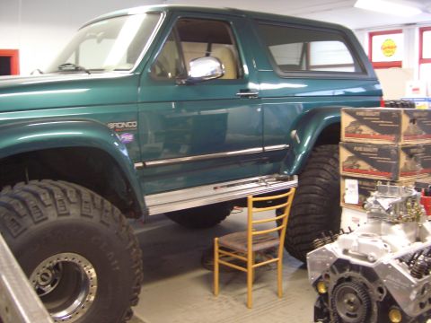 1996 Ford Bronco - This 1996 Ford Bronco features a V8 badge and is equipped with oversized tires, suggesting off-road modifications.