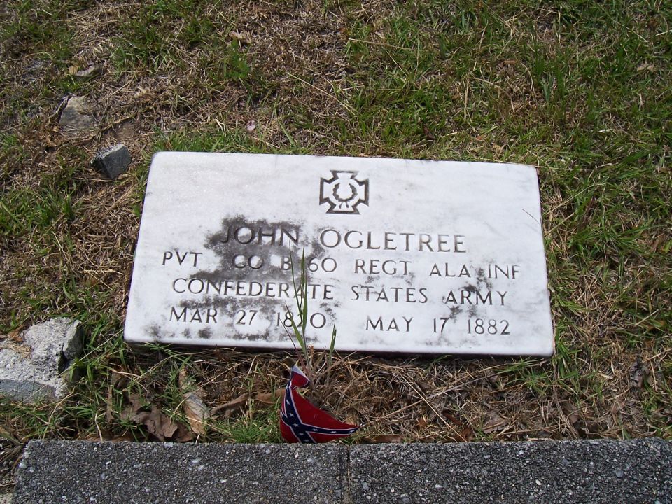 Tombstone for John Ogletree, Pvt Co B 60th Regt Ala Inf Confederate States Army, born March 27, 1820, died May 17, 1882. Small Confederate flag at base
