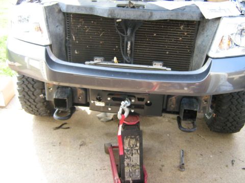 1986 Ford Bronco - The front of a truck is shown with the grille and bumper area visible, an aftermarket winch.