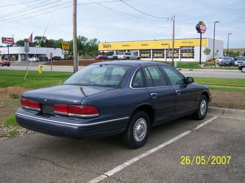 2003 Ford Crown Victoria - This 2003 Ford Crown Victoria is seen from the rear three-quarter angle in a parking lot.