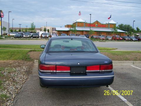 2003 Ford Crown Victoria - Rear view of a dark blue 2003 Ford Crown Victoria parked in a lot.