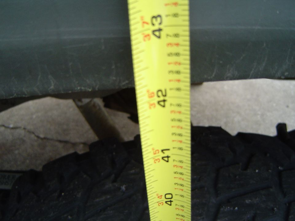 Tape measure showing tire height around 43 inches at a fender