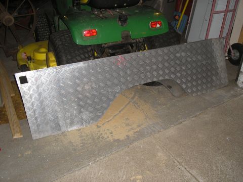 1990 Ford Bronco - Diamond plate metal panel with wheel well cutout, possibly for a truck bed or trailer.
