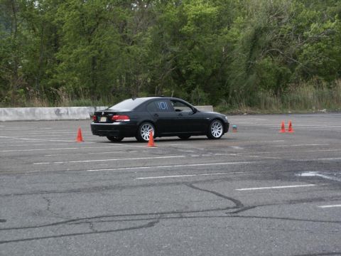 2001 Mercury Grand Marquis - A black BMW 7 Series navigates a course marked by orange cones on a paved lot.