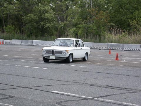 2001 Mercury Grand Marquis - A white BMW 2002 is seen on a track during an event.