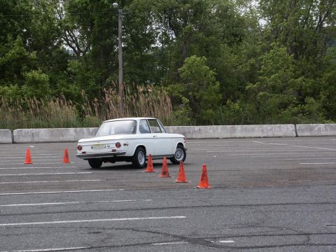 2001 Mercury Grand Marquis - A white coupe navigates an autocross course marked by orange cones.