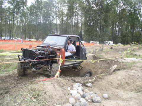 1979 Ford Bronco - A heavily modified off-road vehicle navigates a muddy obstacle course.