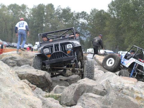 1979 Ford Bronco - Off-road vehicles tackle a challenging rocky terrain during an event.