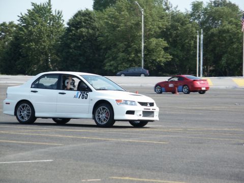 2001 Mercury Grand Marquis - White Mitsubishi Lancer Evolution IX and a red sports car on a race track.