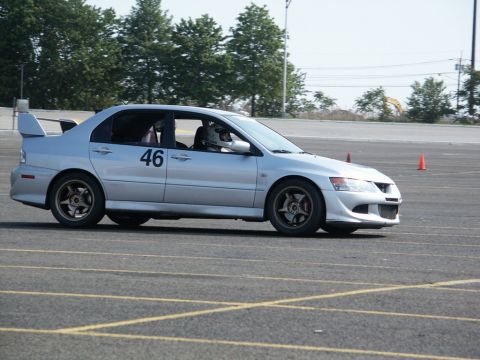 2001 Mercury Grand Marquis - A silver sedan with racing number 46 and a spoiler is seen on a track, possibly during a competition.