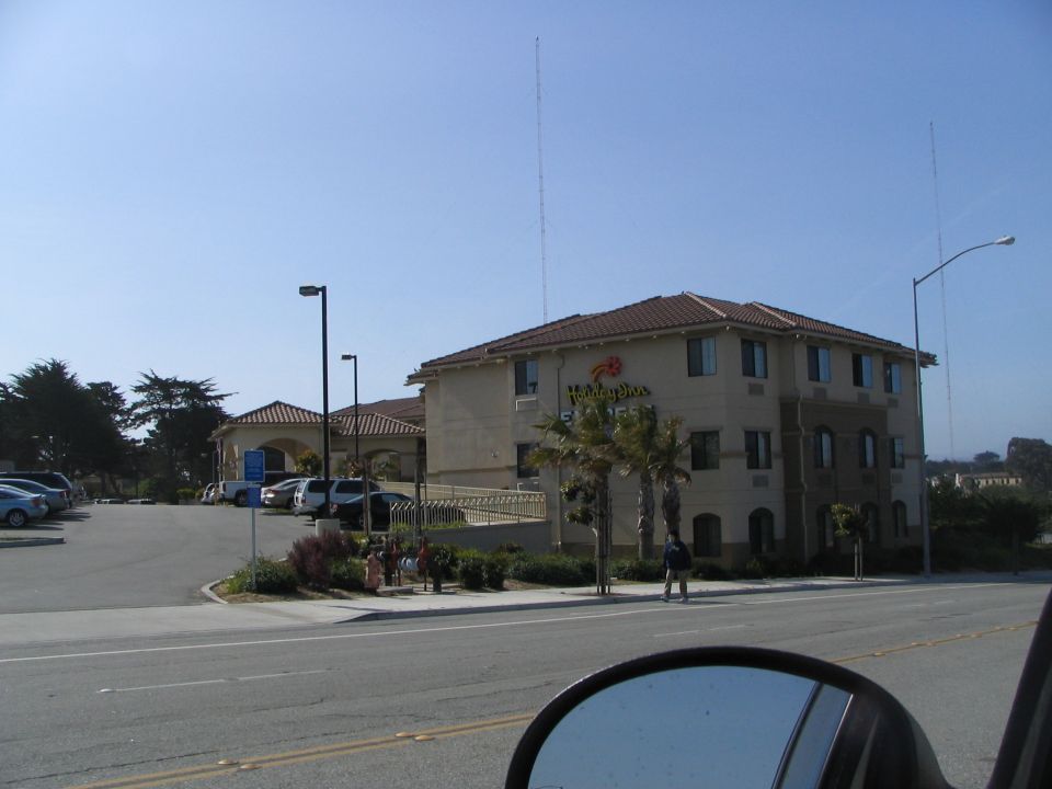 Holiday Inn hotel with parking lot and cars