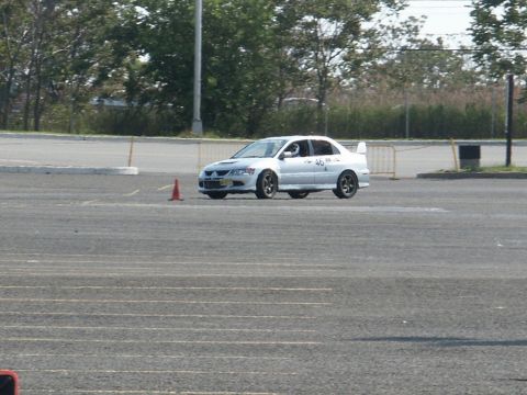 2001 Mercury Grand Marquis - A white sedan with racing modifications navigates a course marked by cones.