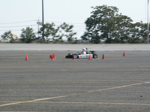 2001 Mercury Grand Marquis - Go-kart racing event with orange cones marking the course on an asphalt track.