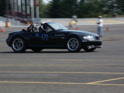2001 Mercury Grand Marquis - Black convertible sports car with racing number 171 on the side, seen on a track.