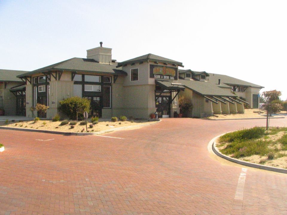 Building with a sign that says "Old Town Saloon & Dining Hall". Paved area in front