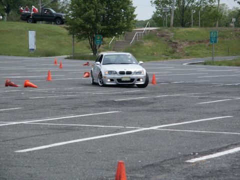 2001 Mercury Grand Marquis - Silver BMW M3 navigates a course marked by orange cones on a paved lot.