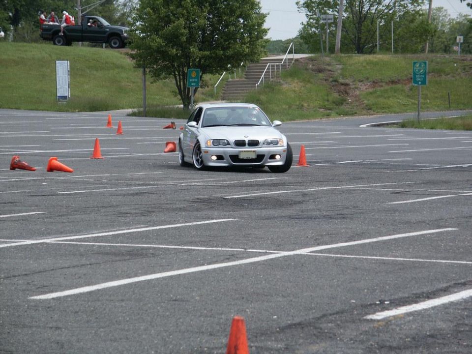 Silver BMW M3 on a race track with orange cones
