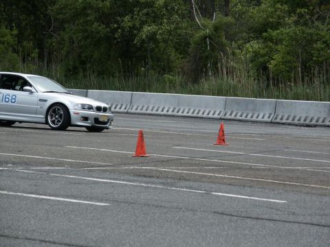 2001 Mercury Grand Marquis - A silver BMW M3, identified by the number 168 on its door, navigates a race track course marked by orange cones.