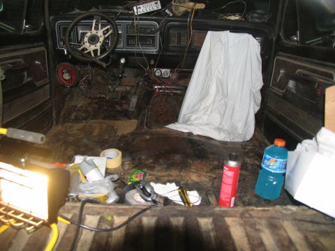 1978 Ford Bronco - The interior of a 1973 Ford Bronco shows signs of extensive work, with a bare floor and exposed components.