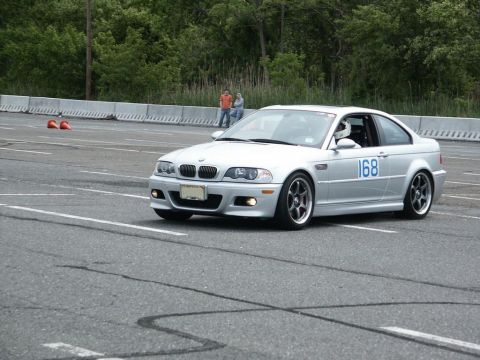 2001 Mercury Grand Marquis - Silver BMW M3 coupe with racing number 168 on its side participates in an autocross event.