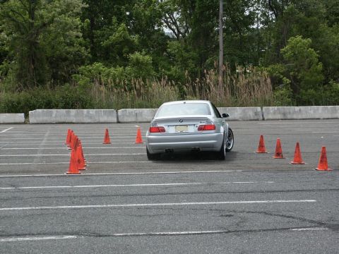 2001 Mercury Grand Marquis - Silver BMW M3 navigates an autocross course marked by orange cones in a paved lot.