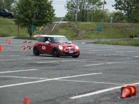 2001 Mercury Grand Marquis - A red Mini Cooper navigates a course marked by orange cones on a sunny day.