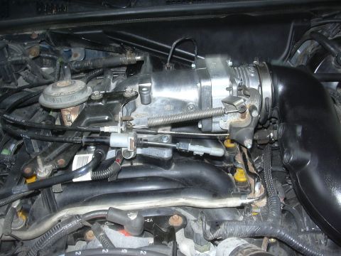 1996 Ford Crown Victoria - Close-up view of engine components, including the throttle body and intake manifold.