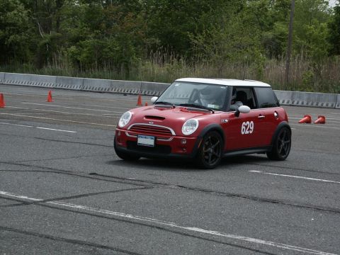 2001 Mercury Grand Marquis - A red Mini Cooper S participates in an autocross event on a paved track.