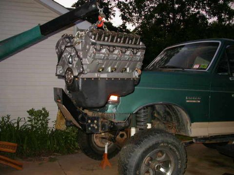 1990 Ford Bronco - Engine installation in progress on a green 1990 Ford Bronco.