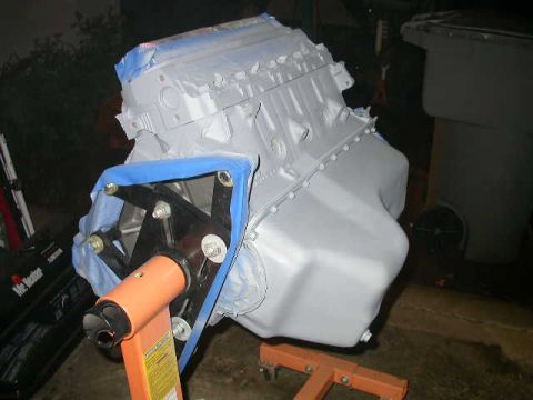 1990 Ford Bronco - Engine block is masked and painted, sitting on an engine stand.
