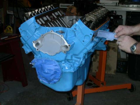 1990 Ford Bronco - V8 engine block on an engine stand, being worked on by a person.