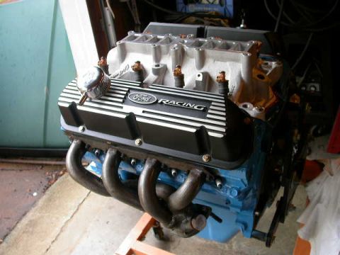 1990 Ford Bronco - Close-up of a Ford Racing engine part, likely a valve cover and intake manifold.
