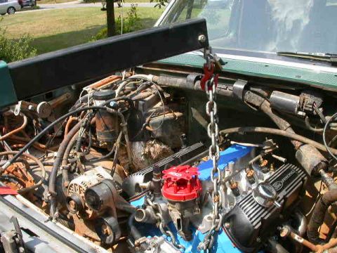 1990 Ford Bronco - Engine bay with engine hoist, showing Ford Racing valve covers.