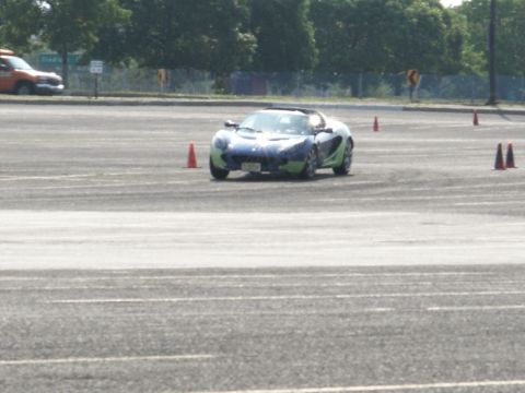 2001 Mercury Grand Marquis - A sports car navigates an autocross course marked by orange cones.