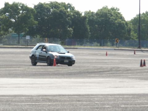 2001 Mercury Grand Marquis - Subaru Impreza WRX wagon competes in an autocross event on a paved track.