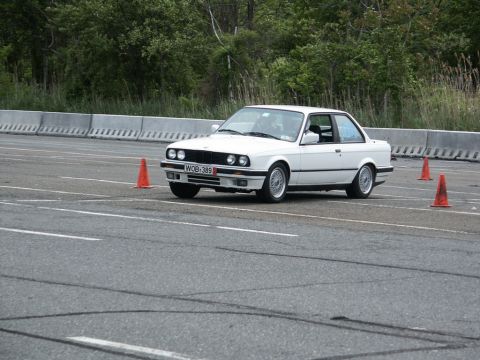 2001 Mercury Grand Marquis - White BMW E30 coupe on a track, likely participating in an autocross event.