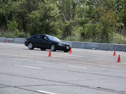 2001 Mercury Grand Marquis - A black sedan with racing number 101 drives through an autocross course marked by orange cones.