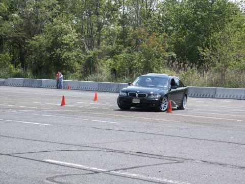2001 Mercury Grand Marquis - A black sedan navigates a course marked by orange cones on a sunny day.