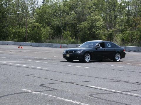 2001 Mercury Grand Marquis - A black BMW sedan, marked with the number 101, navigates an autocross course on a paved track.