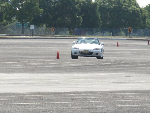 2001 Mercury Grand Marquis - White convertible sports car on an asphalt course with orange cones visible.