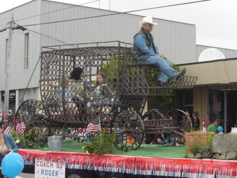 1993 Ford Bronco - A parade float features a carriage constructed entirely of horseshoes, carrying several passengers and a man in a cowboy hat.