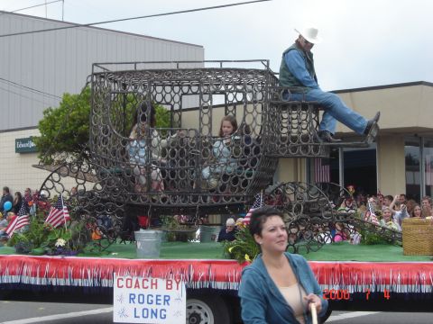 1993 Ford Bronco - A parade float features a unique carriage constructed from horseshoes, with several people riding inside.