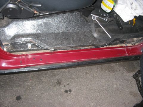 1991 Ford Bronco - Interior view of a car's door sill and floor area, showing some wear and tools.
