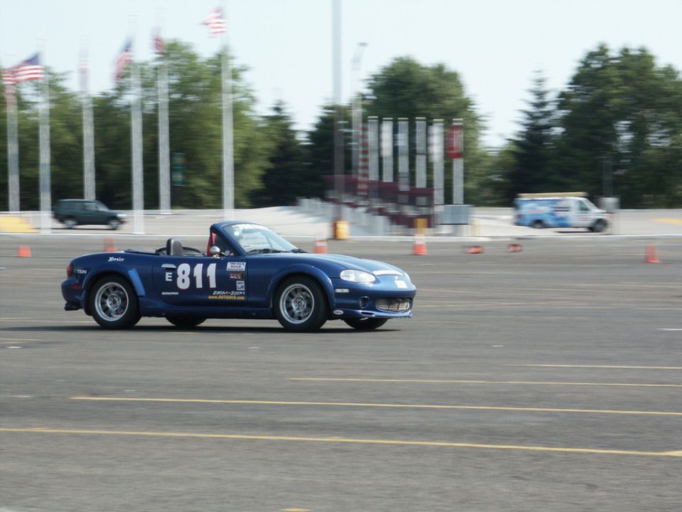 Blue convertible sports car with racing number 811 on its side, seen from the side