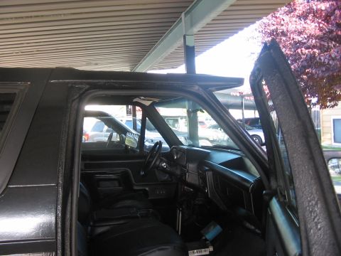 1991 Ford Bronco - Interior view of a 1991 Ford Bronco, with the driver's side door open.