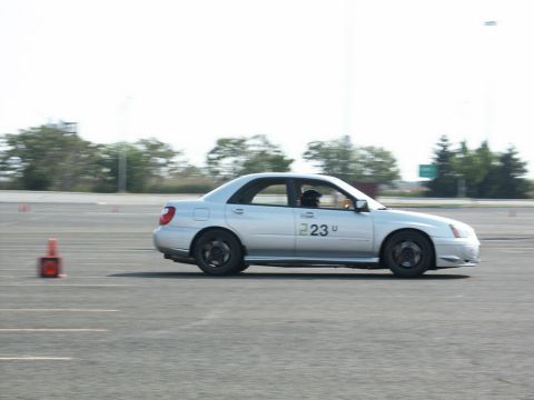 2001 Mercury Grand Marquis - A silver sedan with racing numbers navigates a course marked by traffic cones.