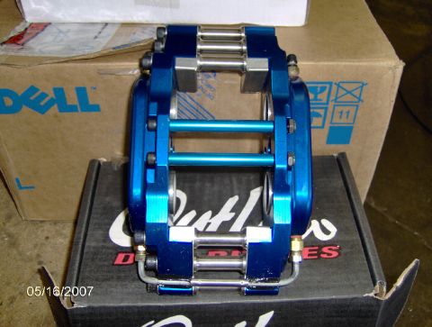 1978 Ford Bronco - A blue brake caliper sits on a box, with a Dell logo visible on a cardboard box behind it.