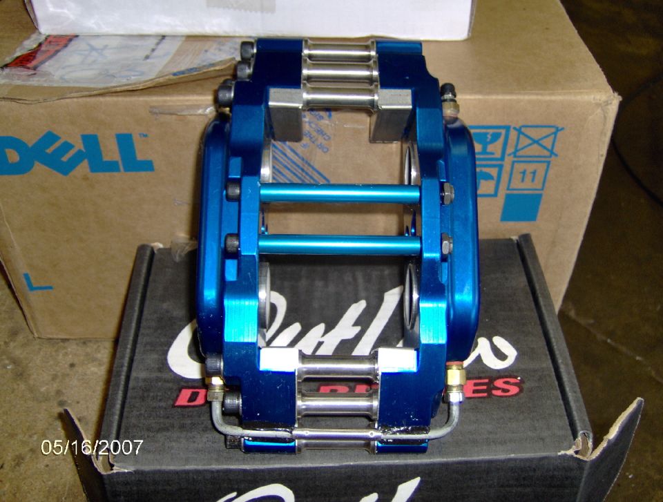 blue brake caliper on a box with Dell logo and "Outlaw" text