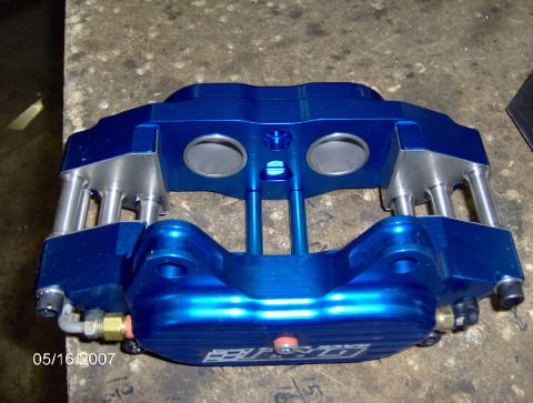1978 Ford Bronco - A blue brake caliper is shown up close, with visible pistons and brake lines.