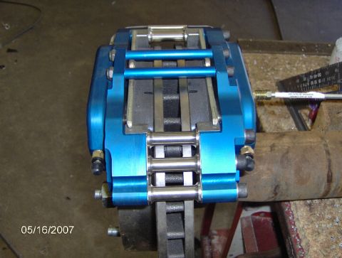 1978 Ford Bronco - Close-up view of a custom blue brake caliper assembly, likely for a vehicle upgrade project.